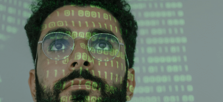 Close up of a man in glasses with reflection of binary