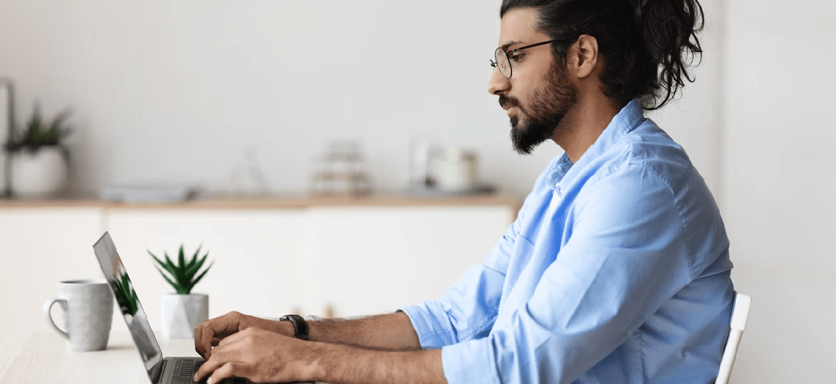 Man at desk working on laptop