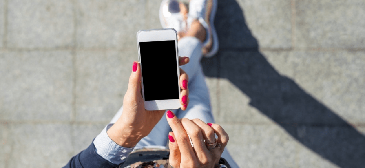 Woman walking with phone in hand