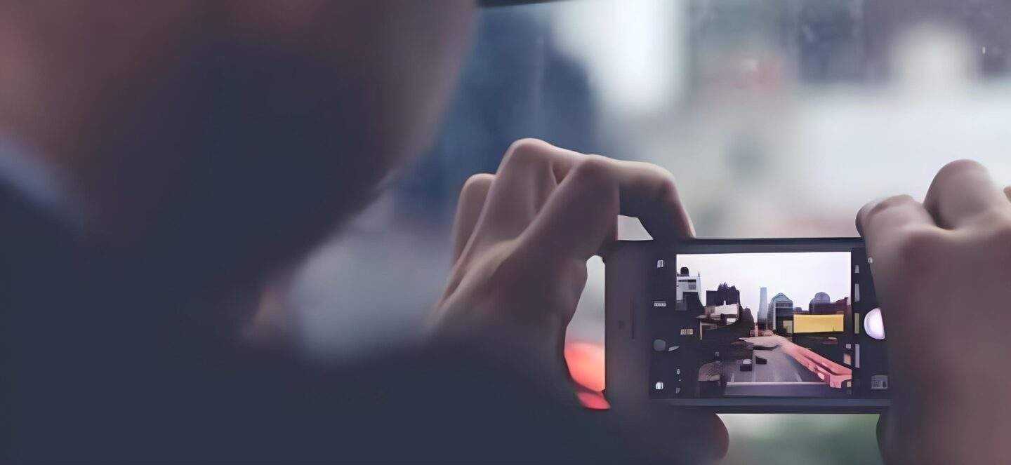 Man taking photo on mobile phone