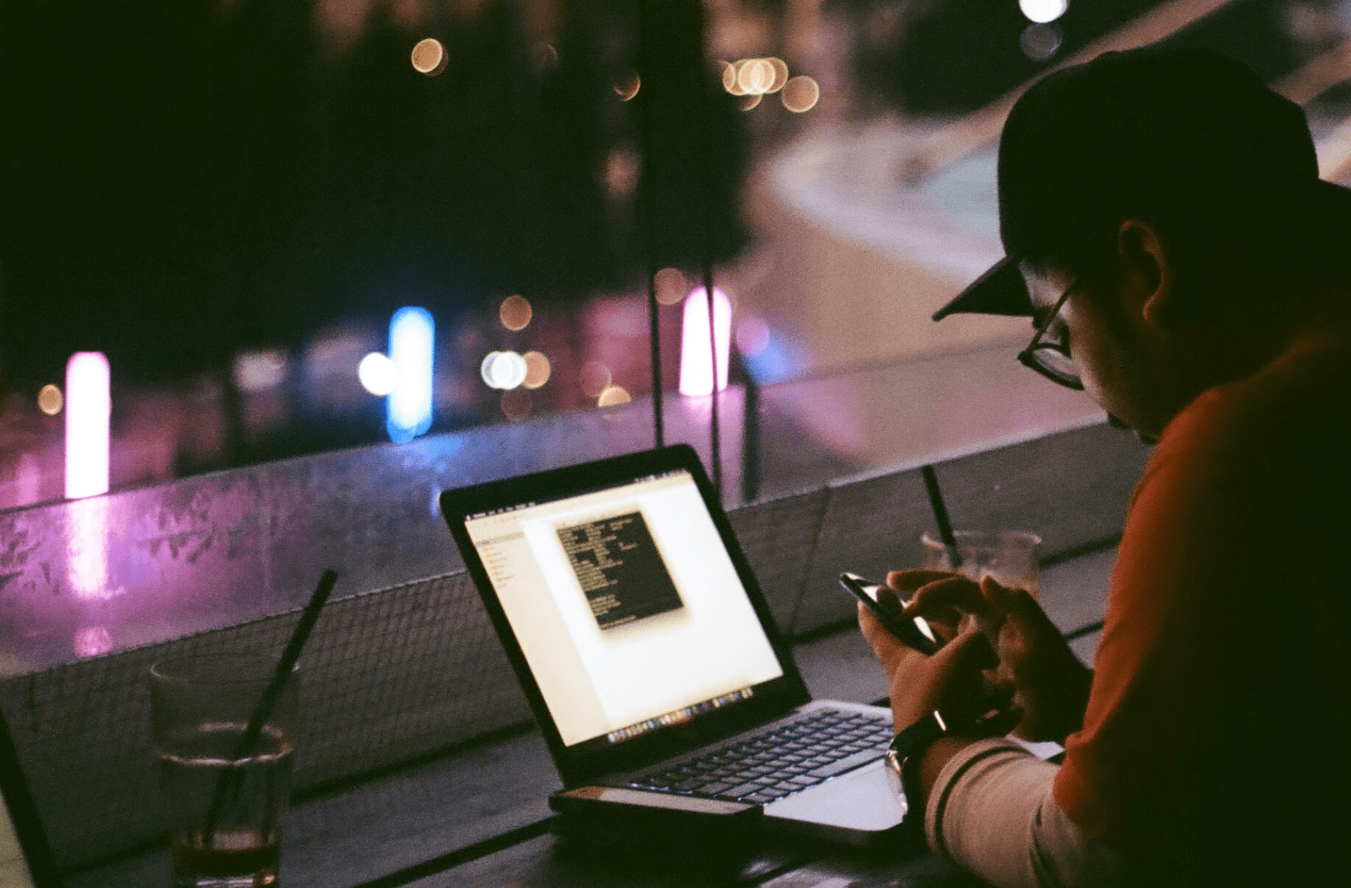 Person on phone and laptop