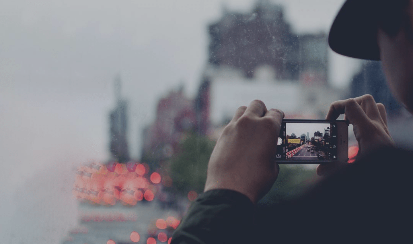 A person taking a photograph of something in the distance