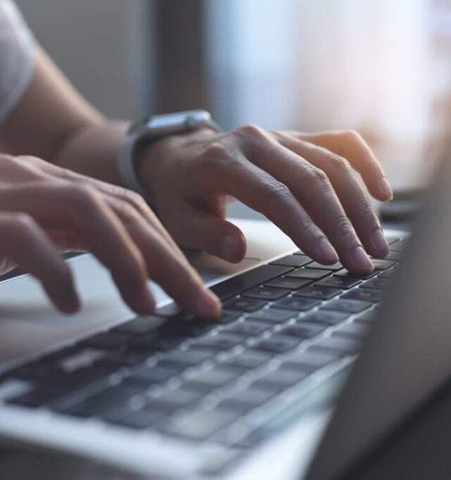 Woman typing on a laptop