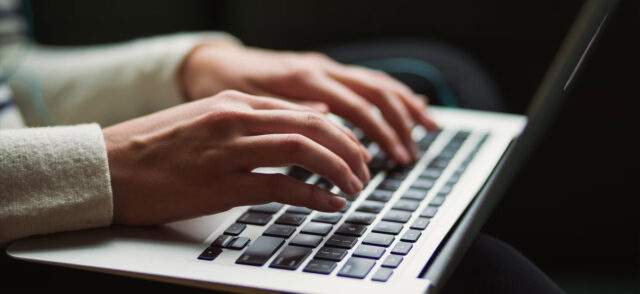 Woman typing on laptop