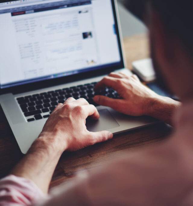 Man typing on a laptop