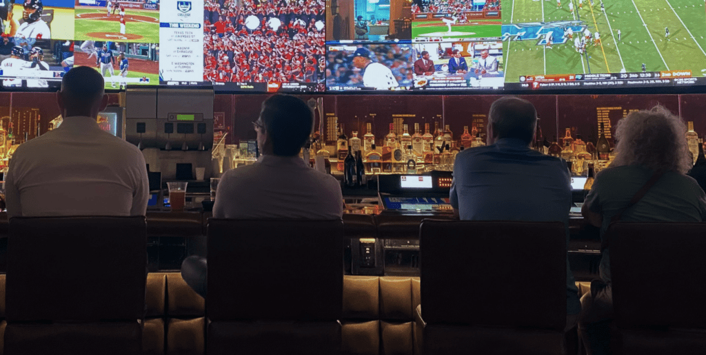 A row of people watching TV screens