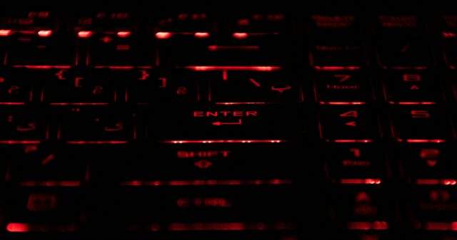 Close-up of a mechanical keyboard with red-lit keys, symbolizing offensive cybersecurity activity.