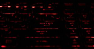 Close-up of a mechanical keyboard with red-lit keys, symbolizing offensive cybersecurity activity.