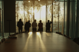 Executives in a boardroom looking out of tall windows toward the horizon, symbolising strategic vision and offensive security leadership.
