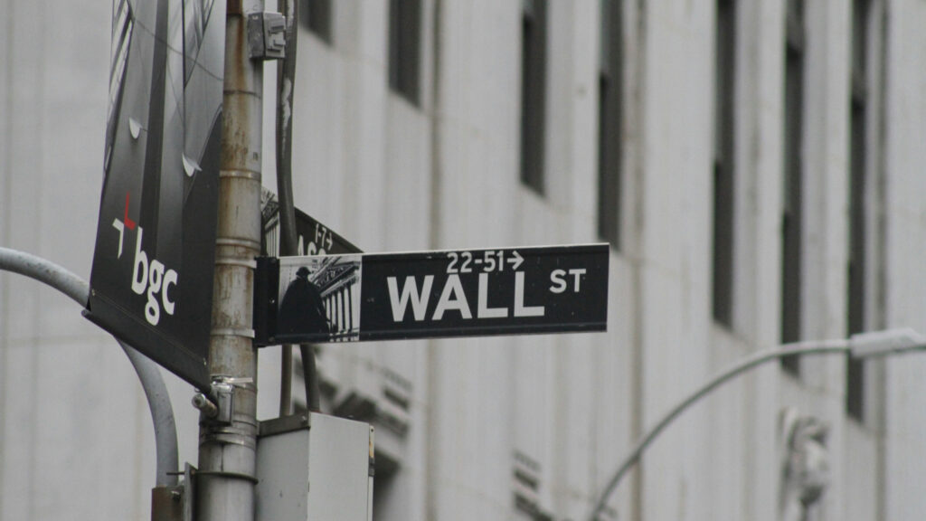 a street sign in wall street, new york city