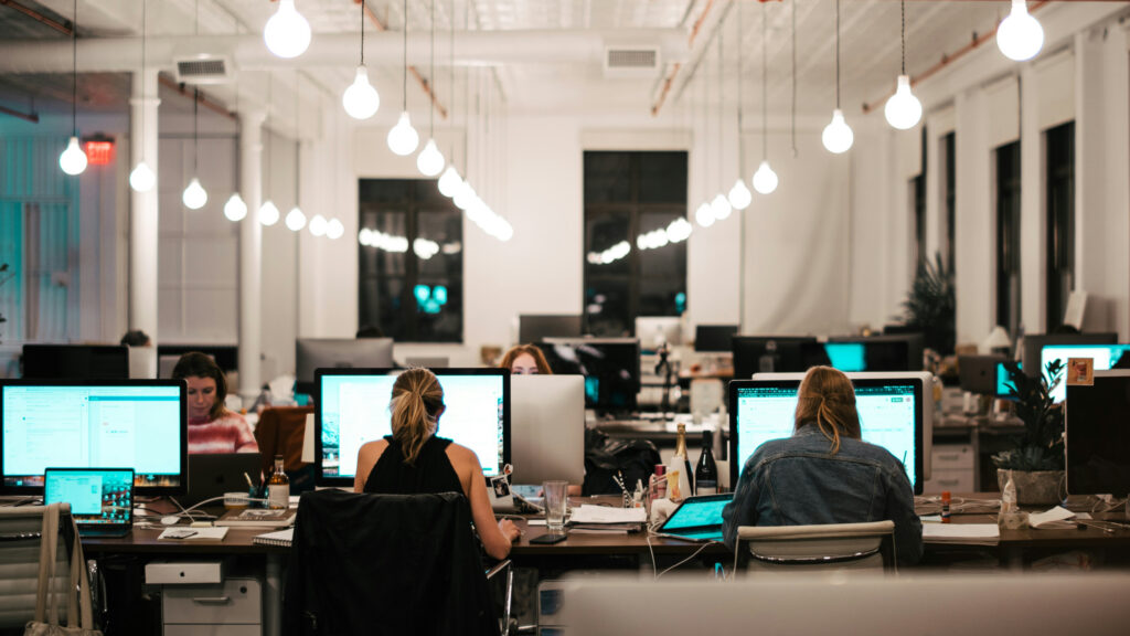 Team of testers working at screens, manual eyes on what automated scanners miss