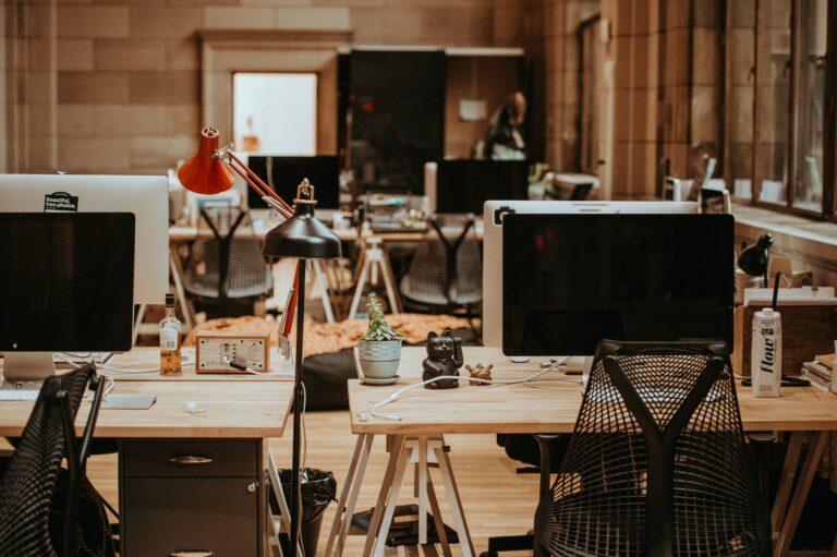 Empty office with many unattended desks and devices