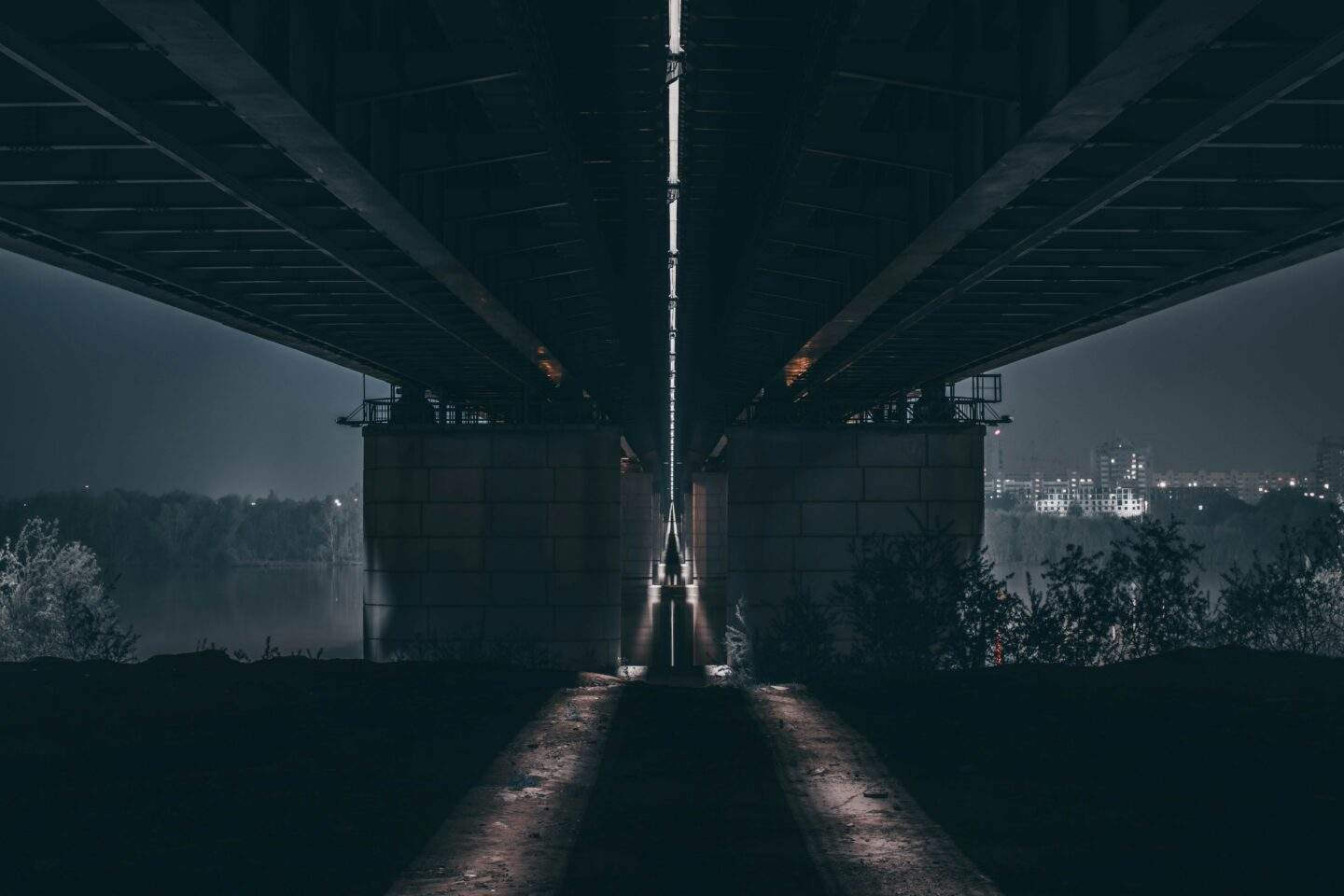 Two dimly lit paths diverging into darkness, representing the choice between a minimum viable DORA testing program and a genuinely resilient one.