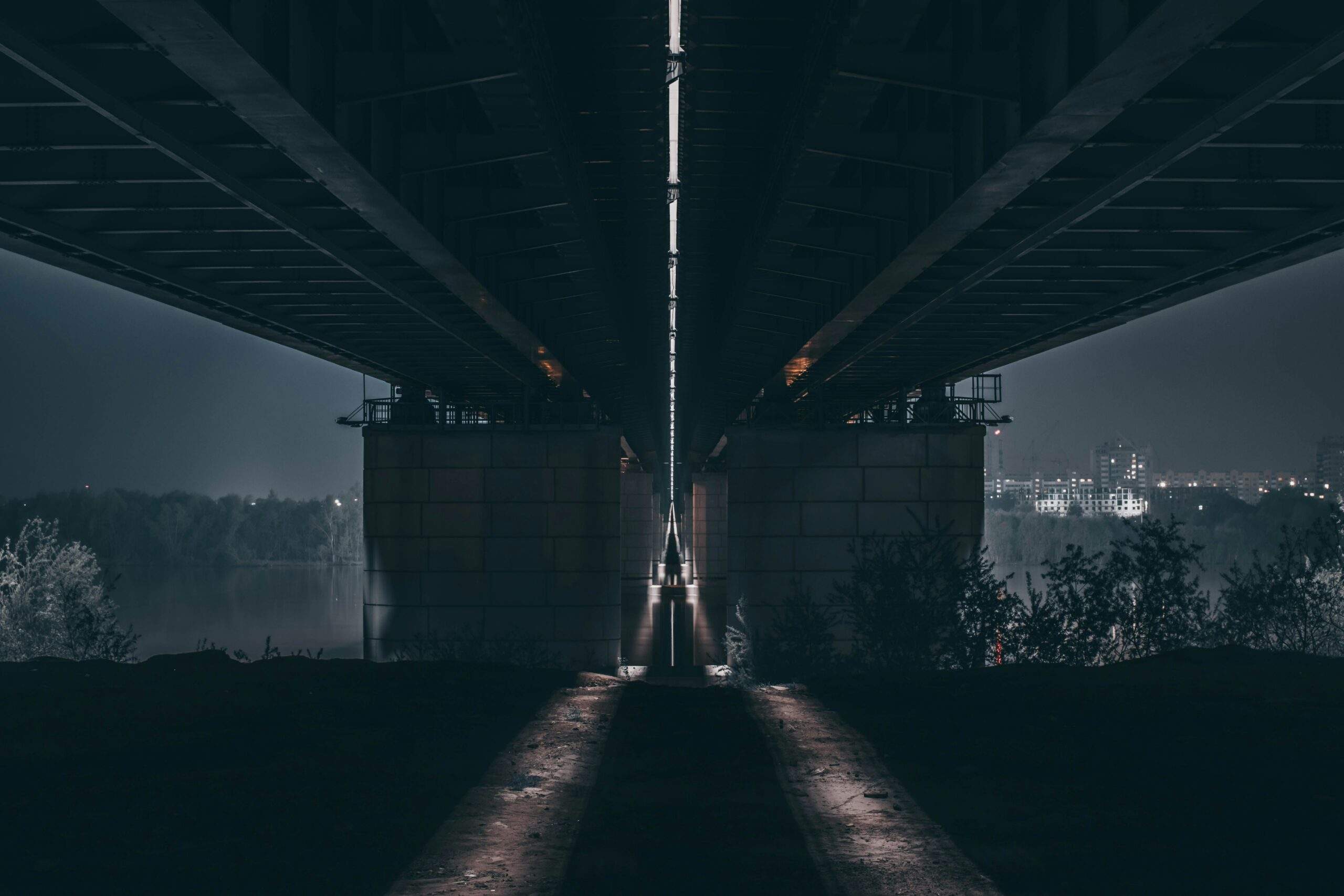 Two dimly lit paths diverging into darkness, representing the choice between a minimum viable DORA testing program and a genuinely resilient one.