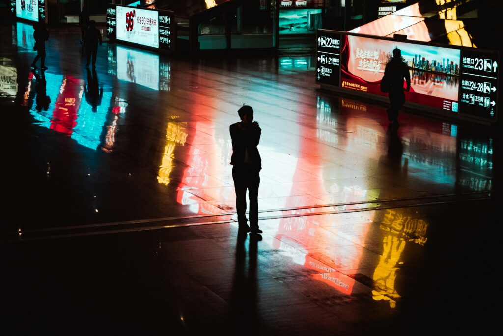 man in the dark surrounded by lights and sensors