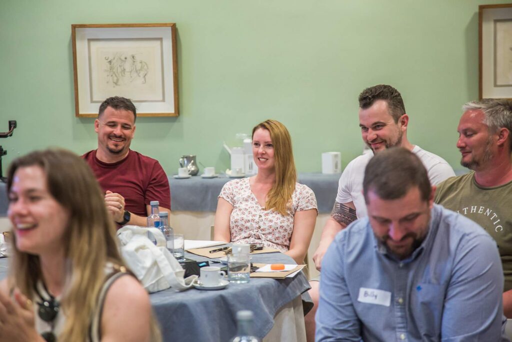 A group of people around a table at SwarmCon